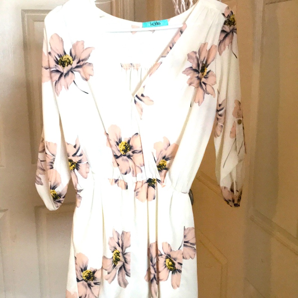 A Cream Colored Long Sleeve Romper
